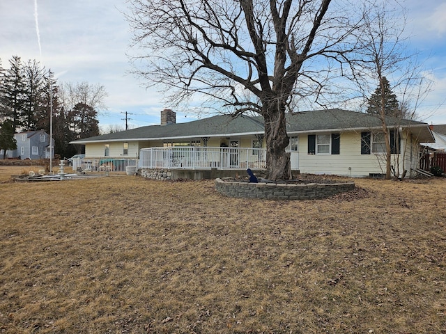 back of property with a lawn