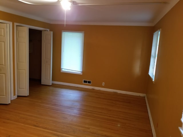 436 6th Ave SW, Cambridge, MN 55008 - unfurnished bedroom featuring light wood-style flooring and a ceiling fan