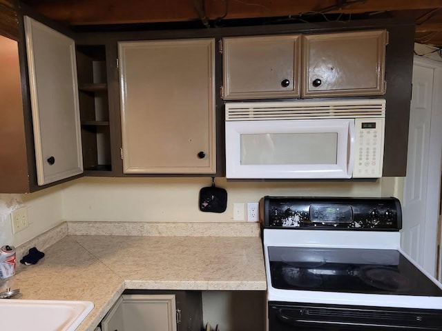 436 6th Ave SW, Cambridge, MN 55008 - kitchen featuring white microwave, electric range oven, and light countertops