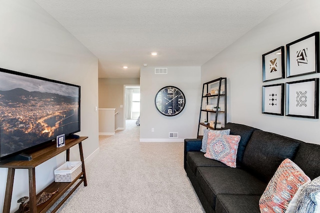 living room featuring light colored carpet and a textured ceiling