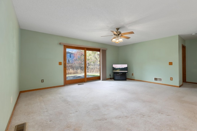 spare room featuring ceiling fan and light colored carpet