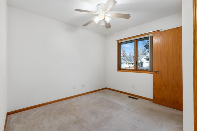 empty room with light carpet and ceiling fan