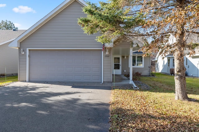 view of front of house featuring a garage and a front yard