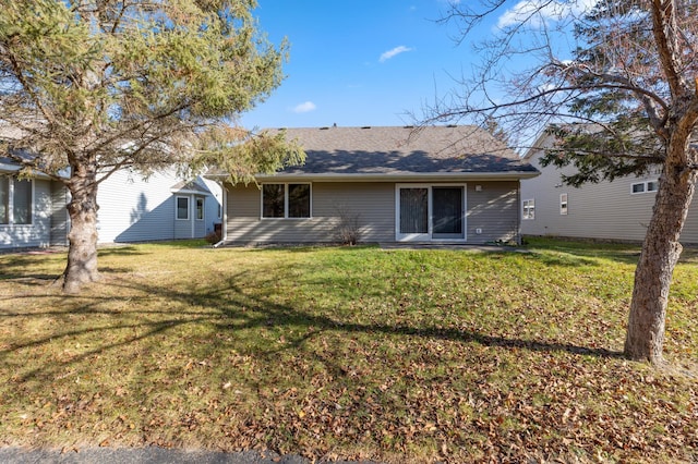 rear view of property with a yard