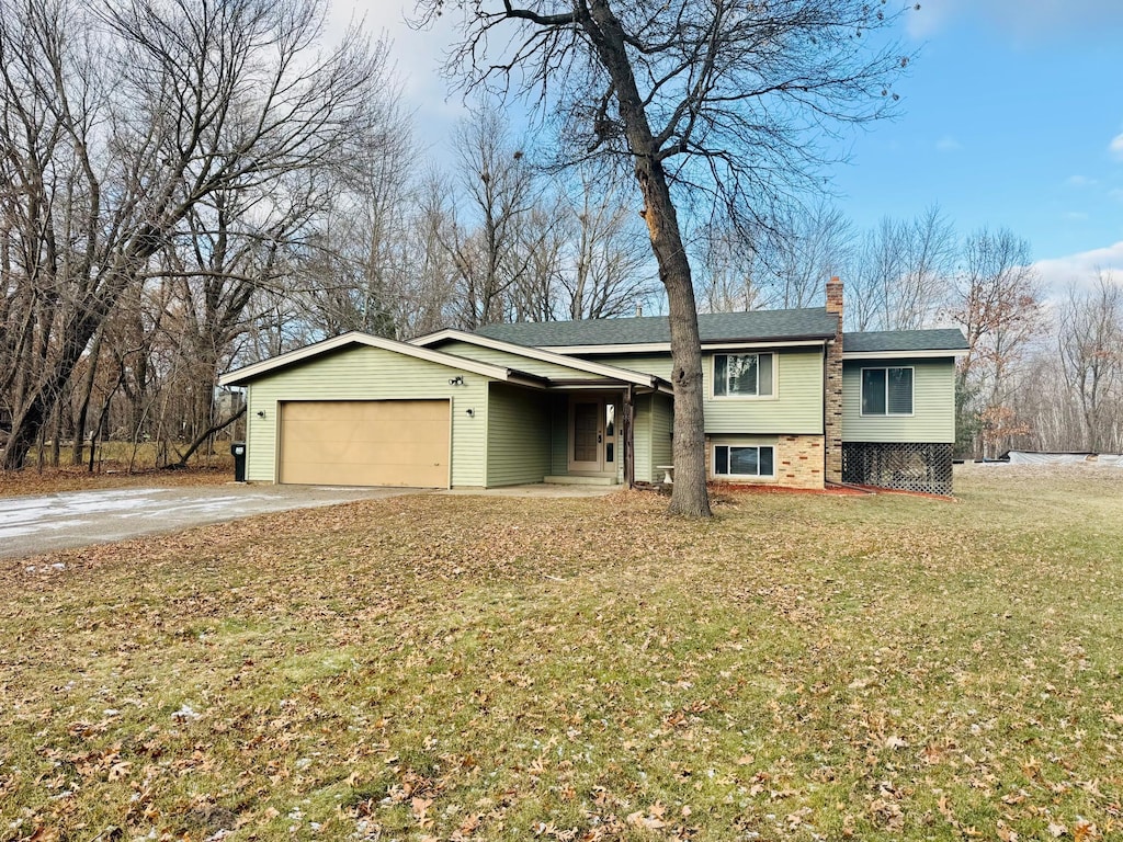 view of front facade with a front yard and a garage