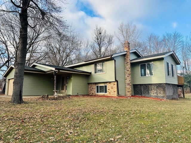 back of property with a lawn and a garage