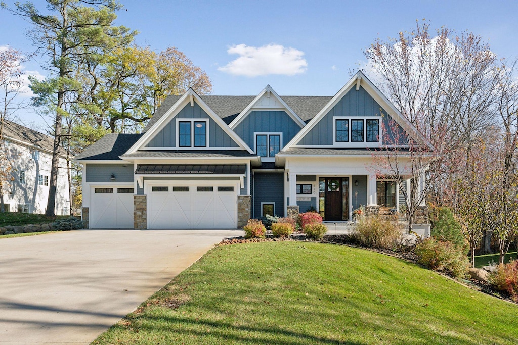 craftsman-style house featuring a front lawn and a garage