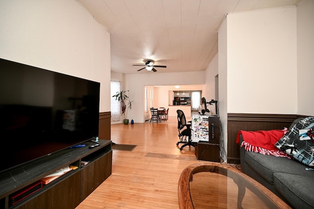 living room with light hardwood / wood-style floors and ceiling fan