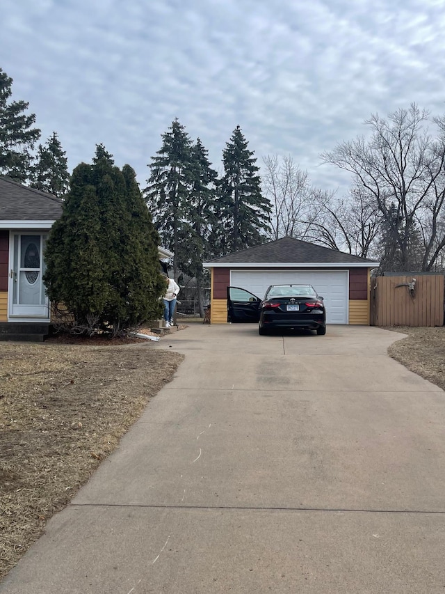 view of property exterior featuring a garage and an outbuilding