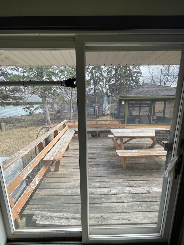 wooden deck with a sunroom