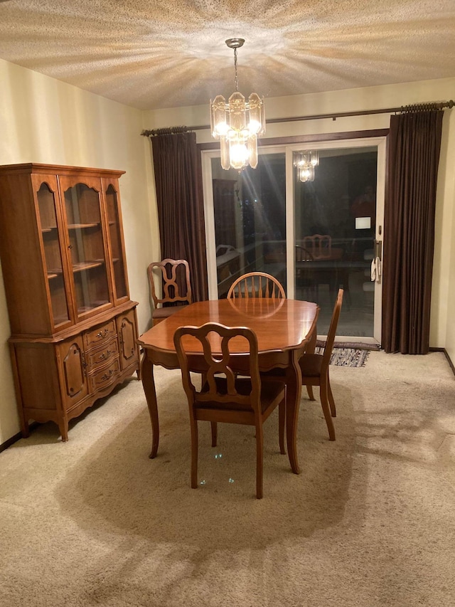 dining area featuring light colored carpet, a textured ceiling, and a notable chandelier