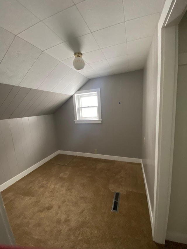 bonus room featuring carpet and vaulted ceiling