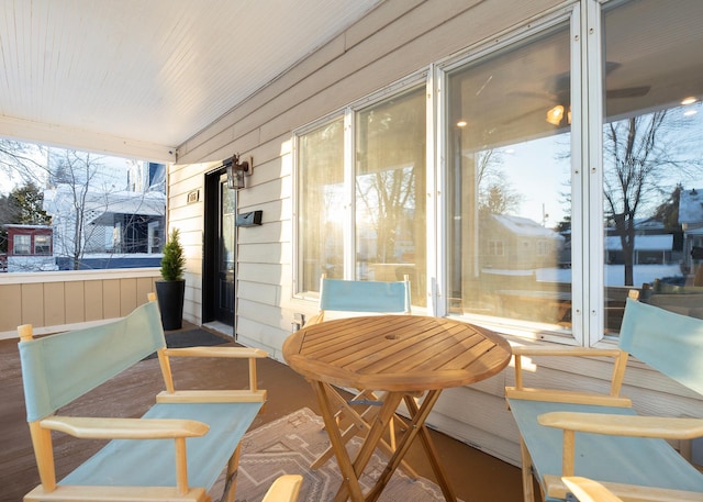 sunroom / solarium with a wealth of natural light and ceiling fan