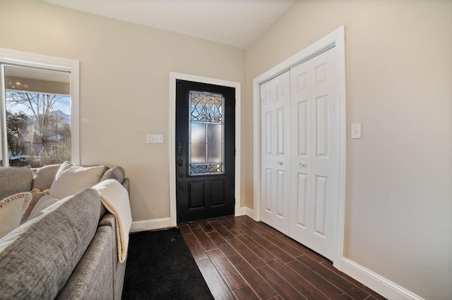 entryway with dark hardwood / wood-style flooring