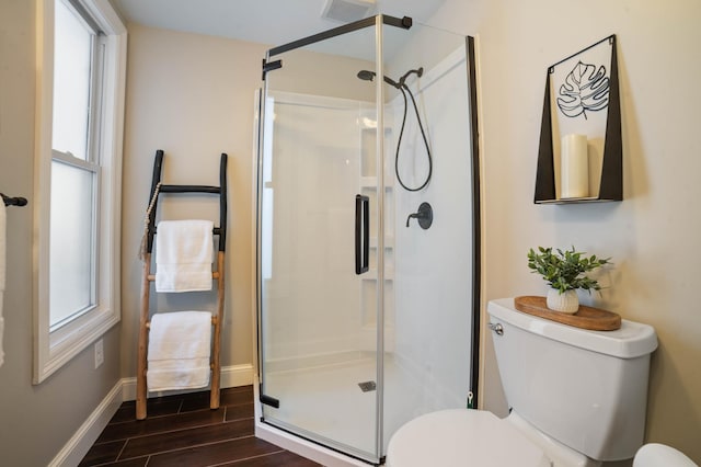 bathroom featuring toilet, hardwood / wood-style floors, and walk in shower