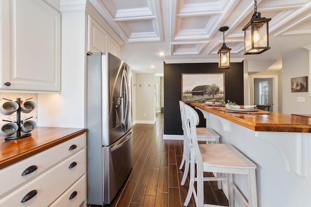 kitchen featuring wood counters, dark hardwood / wood-style floors, stainless steel refrigerator with ice dispenser, decorative light fixtures, and white cabinets