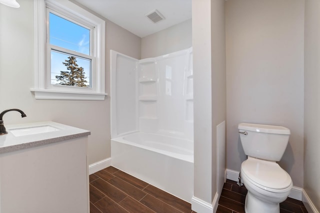 full bathroom with bathtub / shower combination, hardwood / wood-style floors, vanity, and toilet