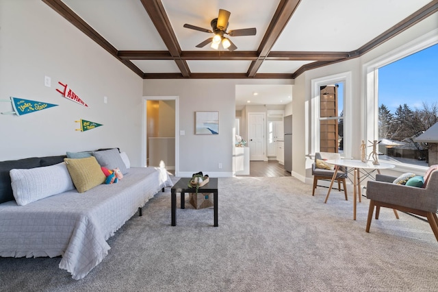 living room with coffered ceiling, crown molding, ceiling fan, beam ceiling, and carpet floors