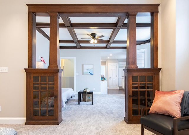 interior space featuring ceiling fan, beam ceiling, carpet floors, and coffered ceiling