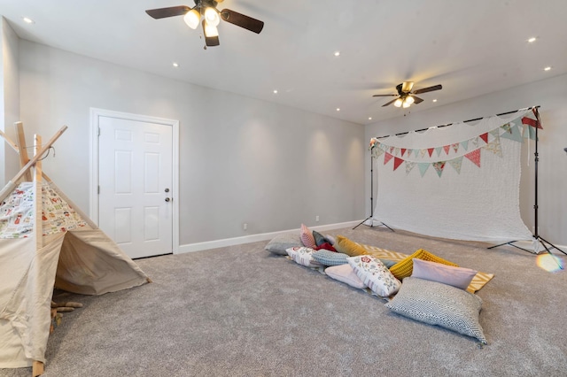 rec room featuring carpet and ceiling fan