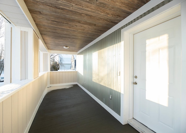 unfurnished sunroom with wood ceiling