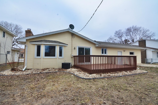 rear view of property with a wooden deck