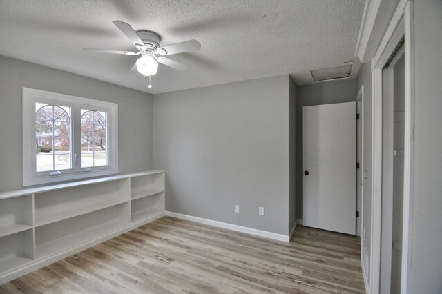 unfurnished bedroom with ceiling fan, light hardwood / wood-style flooring, and a textured ceiling