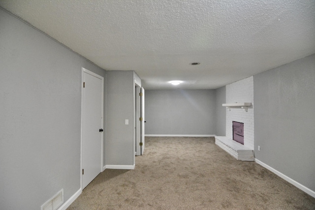 basement featuring a textured ceiling and light colored carpet