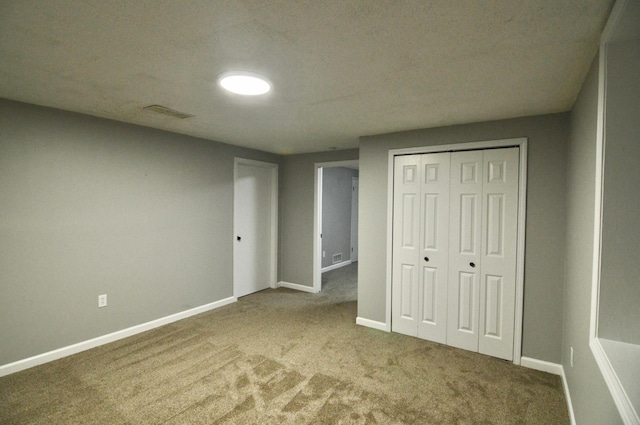 unfurnished bedroom with carpet and a closet