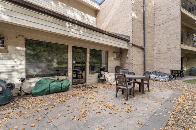 view of patio with an AC wall unit