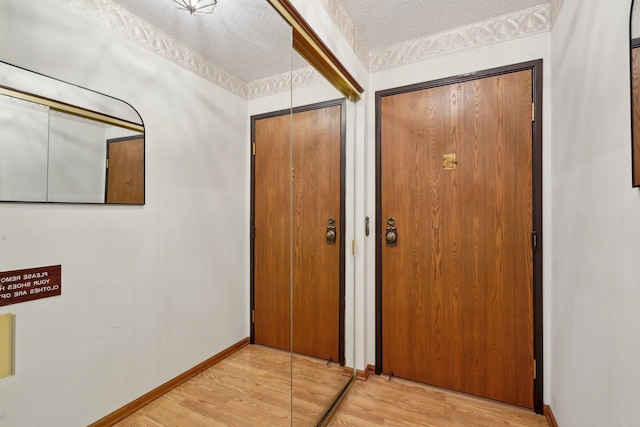 interior space featuring light hardwood / wood-style floors and a textured ceiling