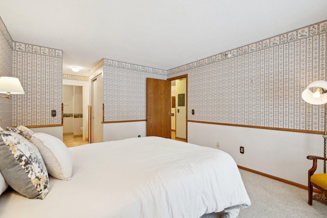 carpeted bedroom featuring ensuite bath