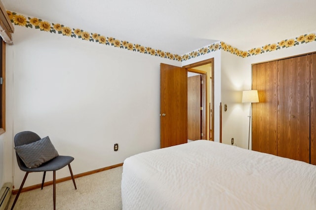 carpeted bedroom featuring a closet and a baseboard radiator