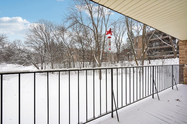 view of snow covered back of property