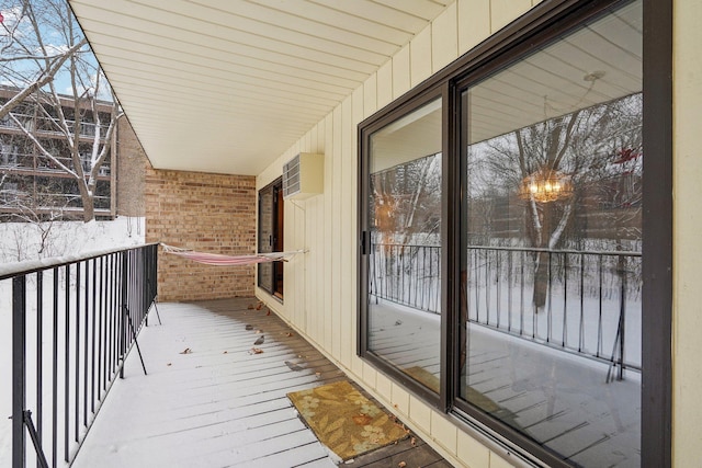 view of snow covered back of property