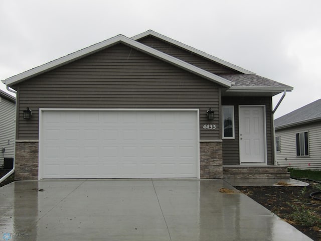 4433 19th St S, Moorhead, MN 56560 - view of front of house with stone siding and driveway