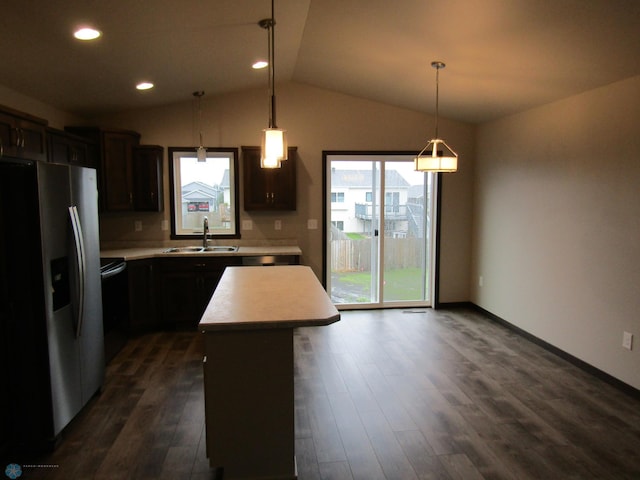 kitchen featuring stainless steel fridge, dark hardwood / wood-style floors, a kitchen island, and pendant lighting