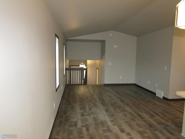 4433 19th St S, Moorhead, MN 56560 - empty room featuring vaulted ceiling and dark wood-style flooring