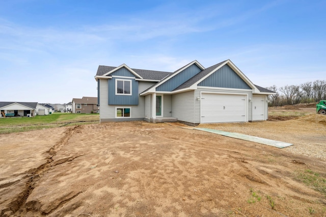 230 Eagle Ridge Dr, Roberts, WI 54023 - view of front facade featuring board and batten siding, a garage, roof with shingles, and driveway