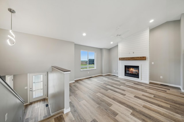 230 Eagle Ridge Dr, Roberts, WI 54023 - unfurnished living room with lofted ceiling, ceiling fan, light wood-style floors, a large fireplace, and recessed lighting