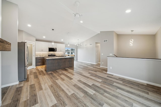 230 Eagle Ridge Dr, Roberts, WI 54023 - kitchen with appliances with stainless steel finishes, vaulted ceiling, a chandelier, recessed lighting, and light countertops
