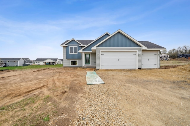 230 Eagle Ridge Dr, Roberts, WI 54023 - view of front of property featuring a garage, driveway, board and batten siding, and a shingled roof