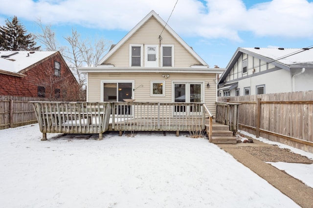 snow covered property with a deck