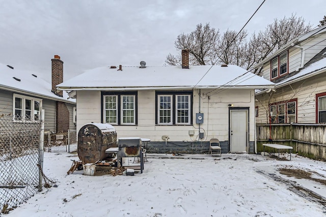 view of snow covered rear of property