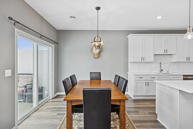 dining room with light wood-type flooring and sink