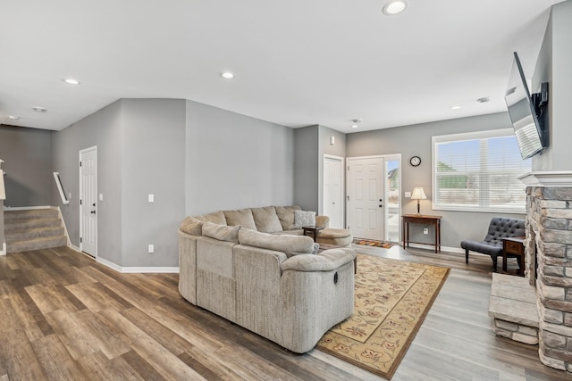 living room with stairway, wood finished floors, and recessed lighting