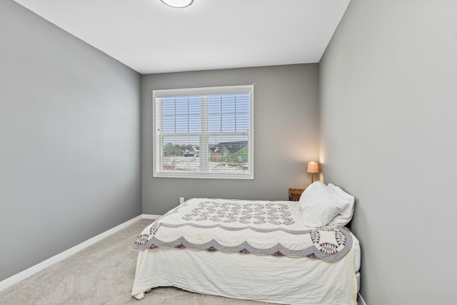 bedroom featuring baseboards and carpet flooring