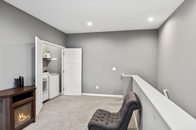 sitting room featuring recessed lighting, light colored carpet, an upstairs landing, baseboards, and washing machine and clothes dryer