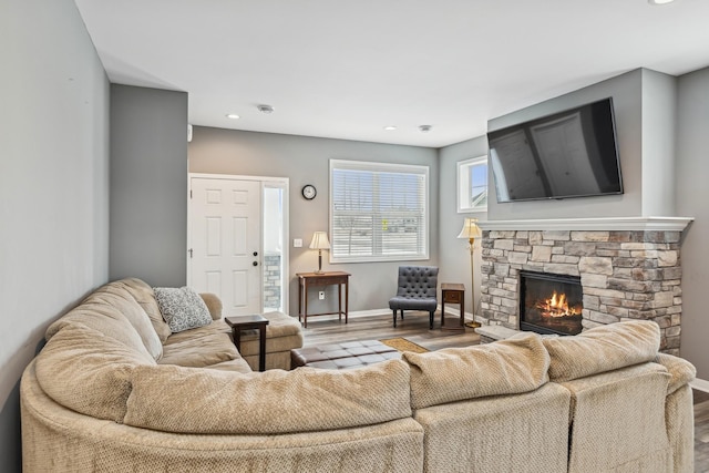 living room with light wood-style floors, recessed lighting, a fireplace, and baseboards