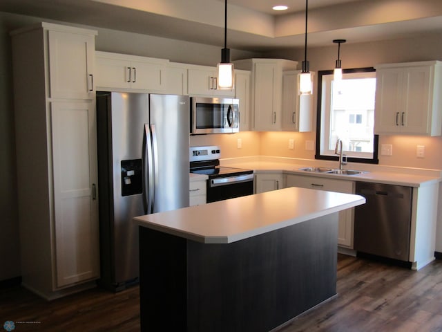 kitchen featuring white cabinets, dark hardwood / wood-style floors, a kitchen island, and stainless steel appliances